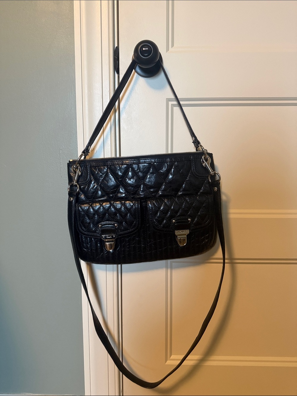 Coach “Poppy” Black Quilted Shoulder Bag with Front Buckle Pockets.